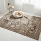 Patterned rug with a dog bed and toys on a light wood floor.