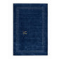 A dark navy blue rectangular rug with a textured surface, featuring a decorative border of small white dots and a gold monogram logo in the center, shown against a plain white background.