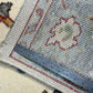 Close-up of a rug with a measuring tape for scale