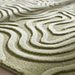 Close-up of a textured green rug with wavy patterns