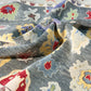 Close-up of patterned fabric with blue, red, yellow, and white colors.