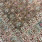 Close-up of a patterned rug with intricate designs and colors.