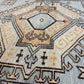 Close-up of a patterned rug with geometric design and text.