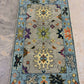 Decorative rug with floral and geometric patterns on a neutral background