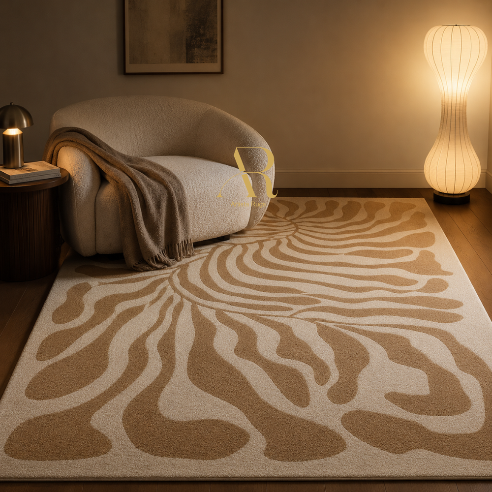 A large area rug with a beige and cream zebra-like wavy pattern, styled in a cozy living room next to a curved armchair and a glowing floor lamp.