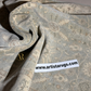 Roll of patterned rug fabric with Artista Rugs logo and website.