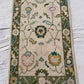 Decorative floral rug on a light gray surface