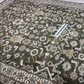 Close-up of a patterned rug with a visible brand label.
