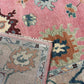 Close-up of a patterned rug with a visible brand label.
