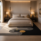 A modern bedroom scene with a large black area rug featuring abstract gold and white curved line patterns in the foreground. The room is styled symmetrically with a beige bed, matching nightstands, and warm ambient lighting.