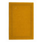 A rectangular mustard yellow area rug with a decorative border of small black perforations and a small white embroidered logo near the top left, shown flat against a white background.