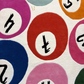 Pattern of colorful circles with black symbols on a white background