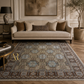 Living room with a patterned rug, beige sofa, and decorative elements.