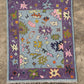 Colorful patterned rug on a textured floor