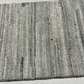 Textured gray rug on a light gray floor