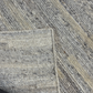 Close-up of a textured gray carpet with a subtle pattern