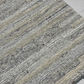Textured rug with a pattern of gray and beige colors on a neutral background