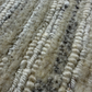 Close-up of textured beige carpet with wavy pattern