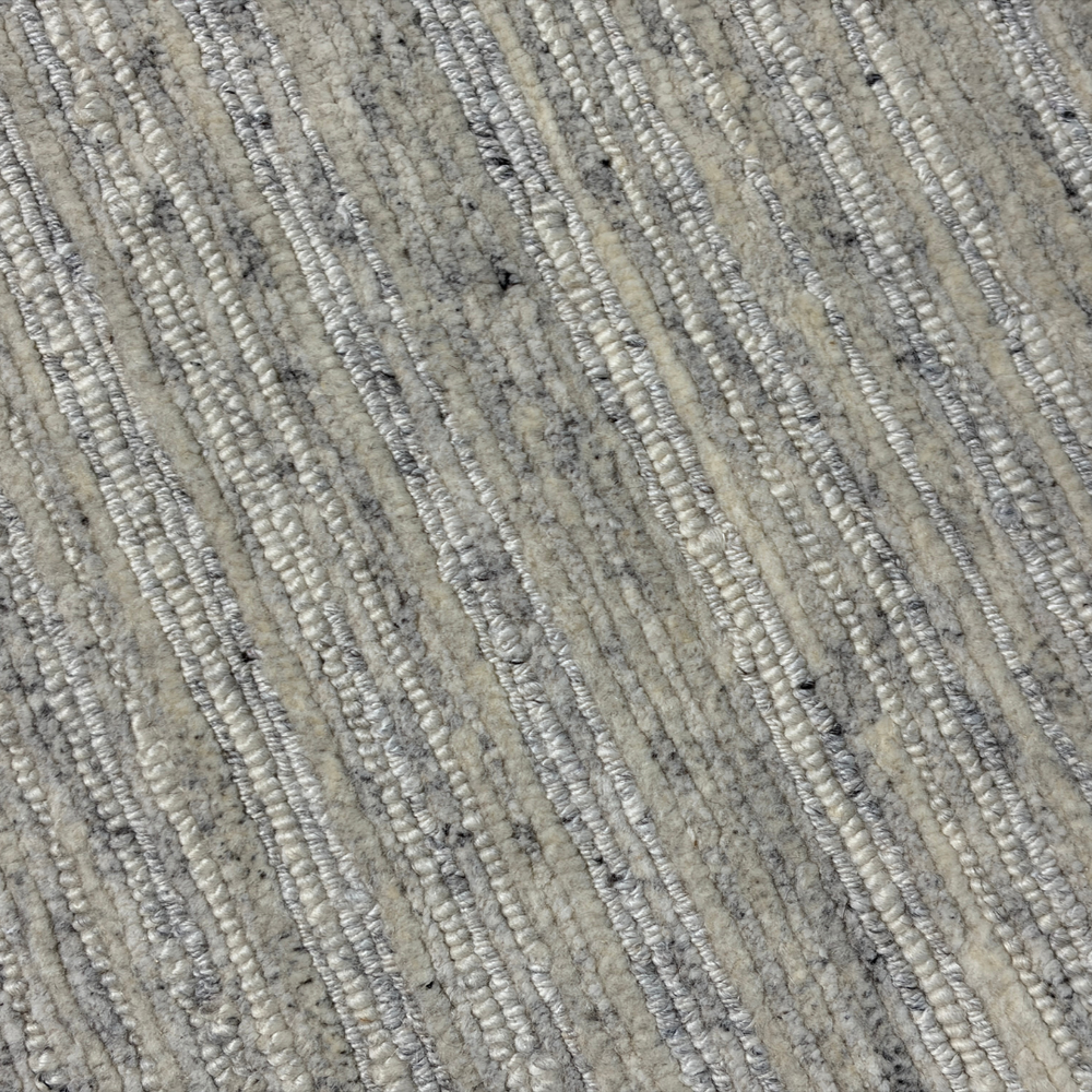 Close-up of textured beige carpet with subtle pattern