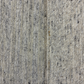 Close-up of textured gray carpet with visible wear and tear.