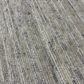 Close-up of textured beige and gray carpet