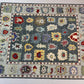 Decorative rug with colorful geometric patterns on a plain background