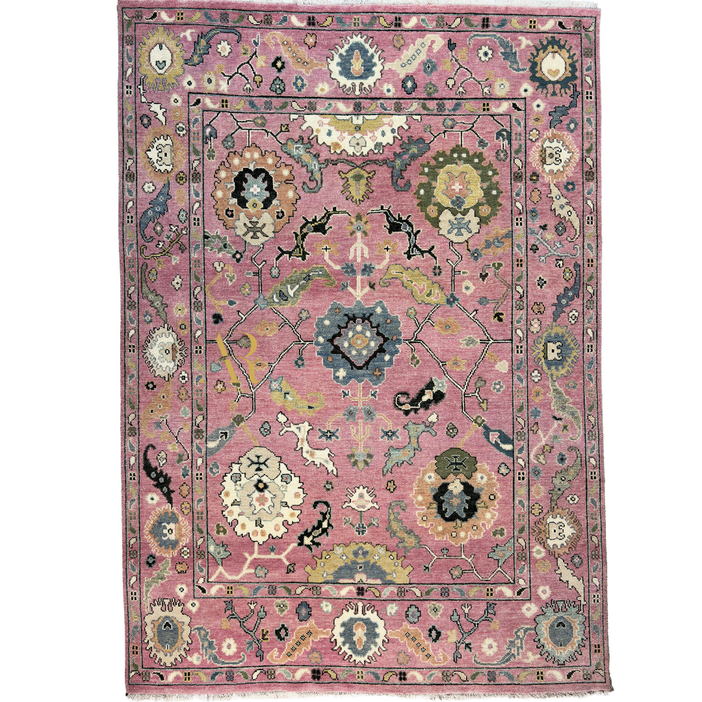 Decorative rug with intricate patterns on a pink background