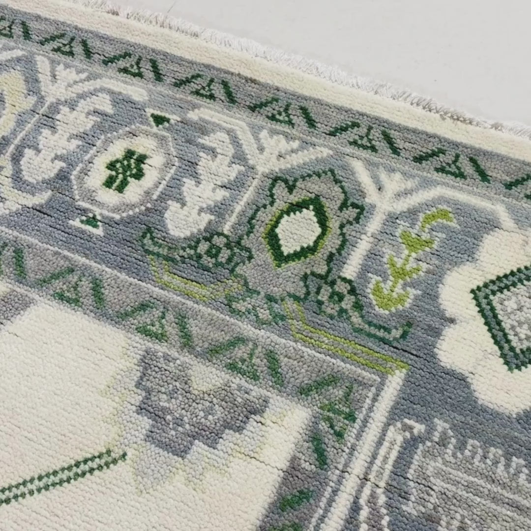 Close-up of a patterned rug with a visible brand label.