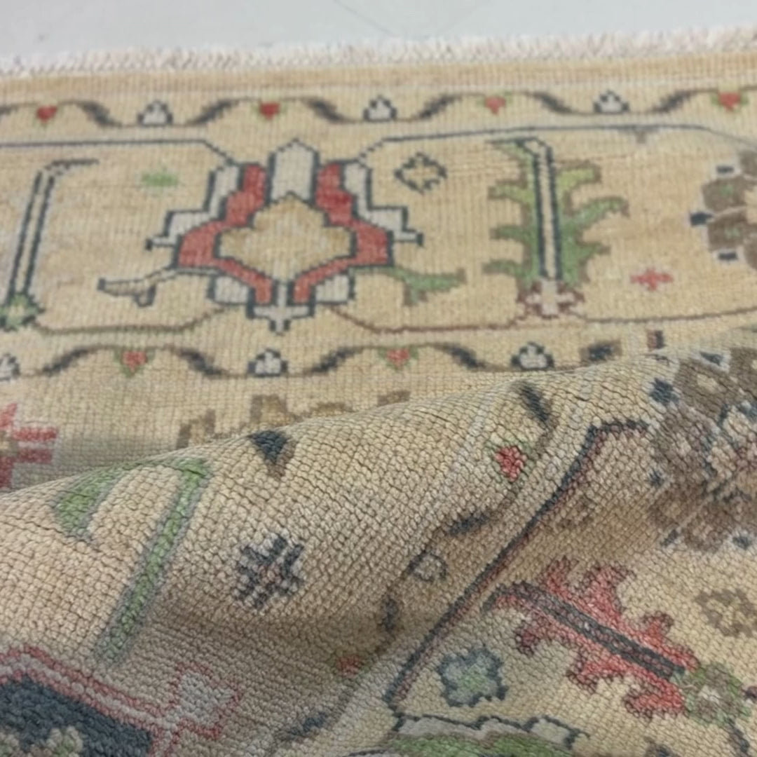 Close-up of a patterned rug with a visible textures.