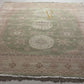 Close-up of two patterned rugs with geometric and floral designs.
