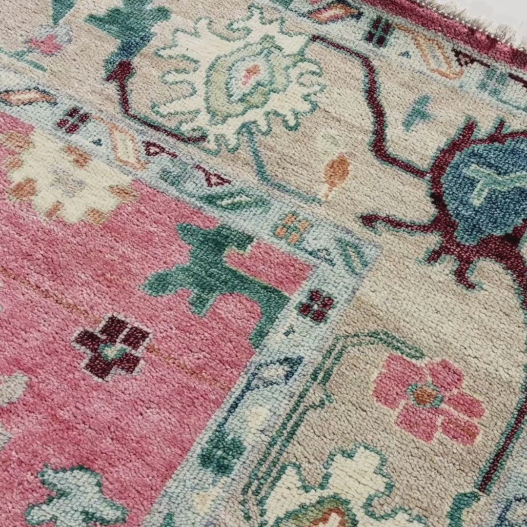 Close-up of a patterned rug with a visible brand label.