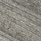 Close-up of a patterned rug with a visible textures.