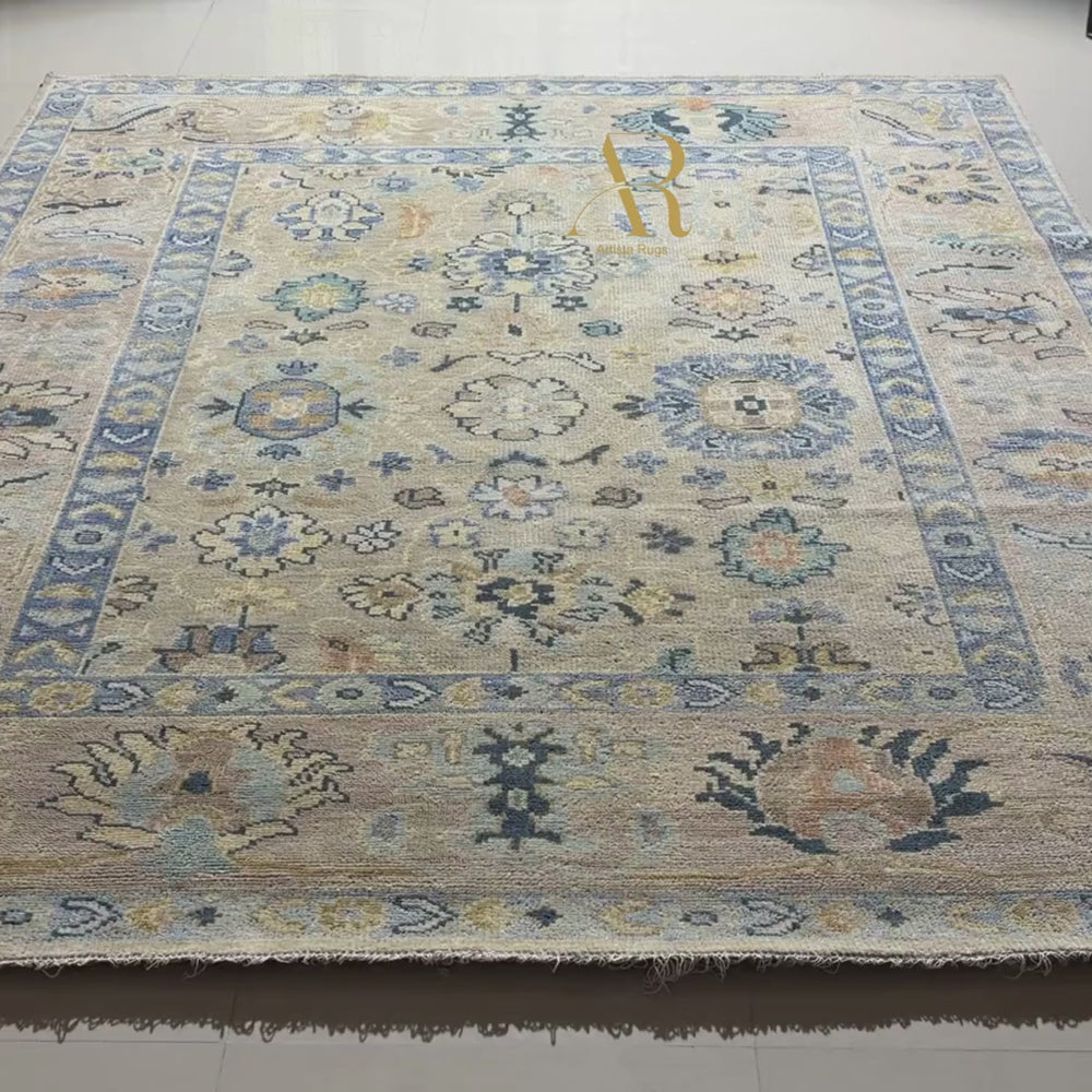 Close-up of a patterned rug with decorative elements and a visible brand label.