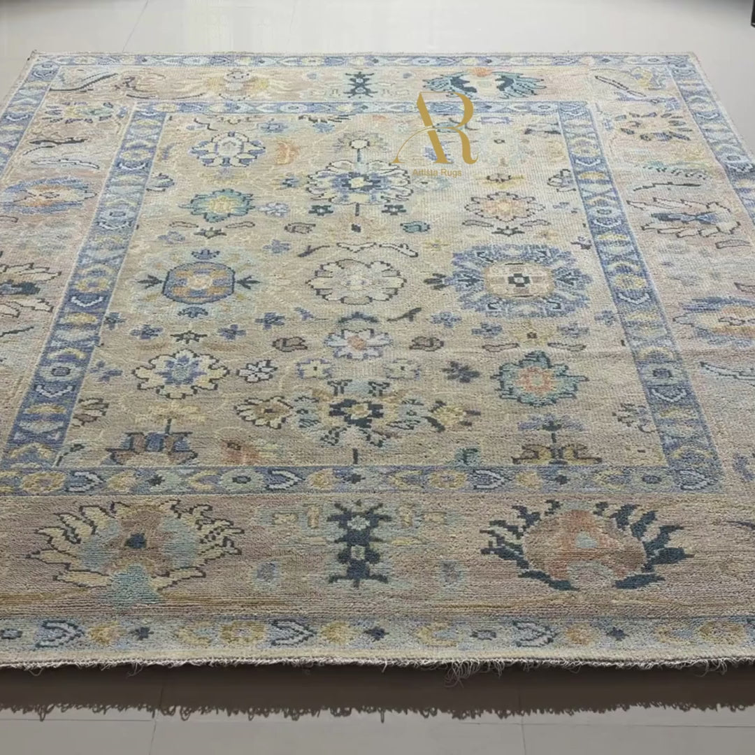 Close-up of a patterned rug with decorative elements and a visible brand label.