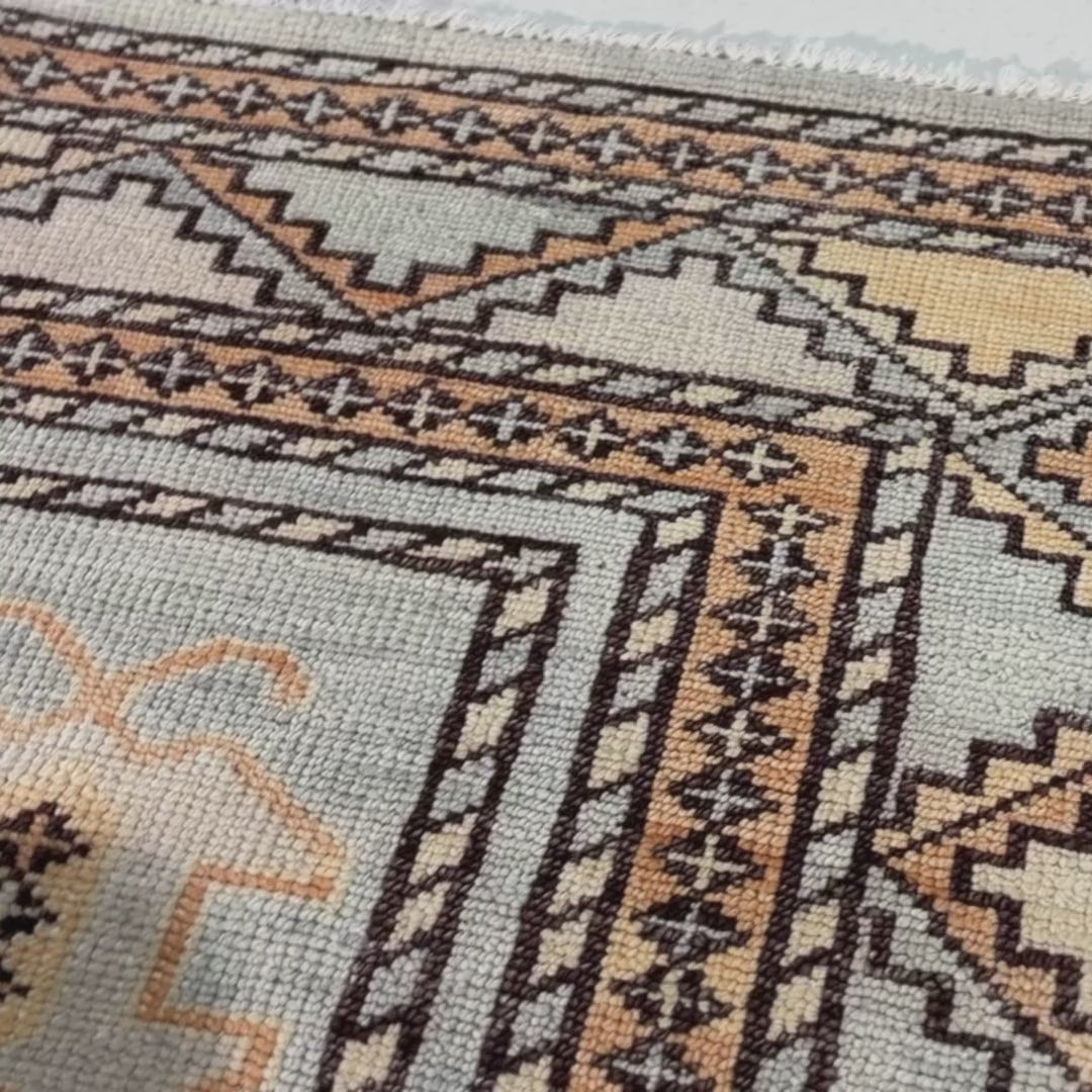 Close-up of a patterned rug with a visible textures.