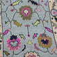 Close-up of a patterned fabric with floral designs on a light blue background