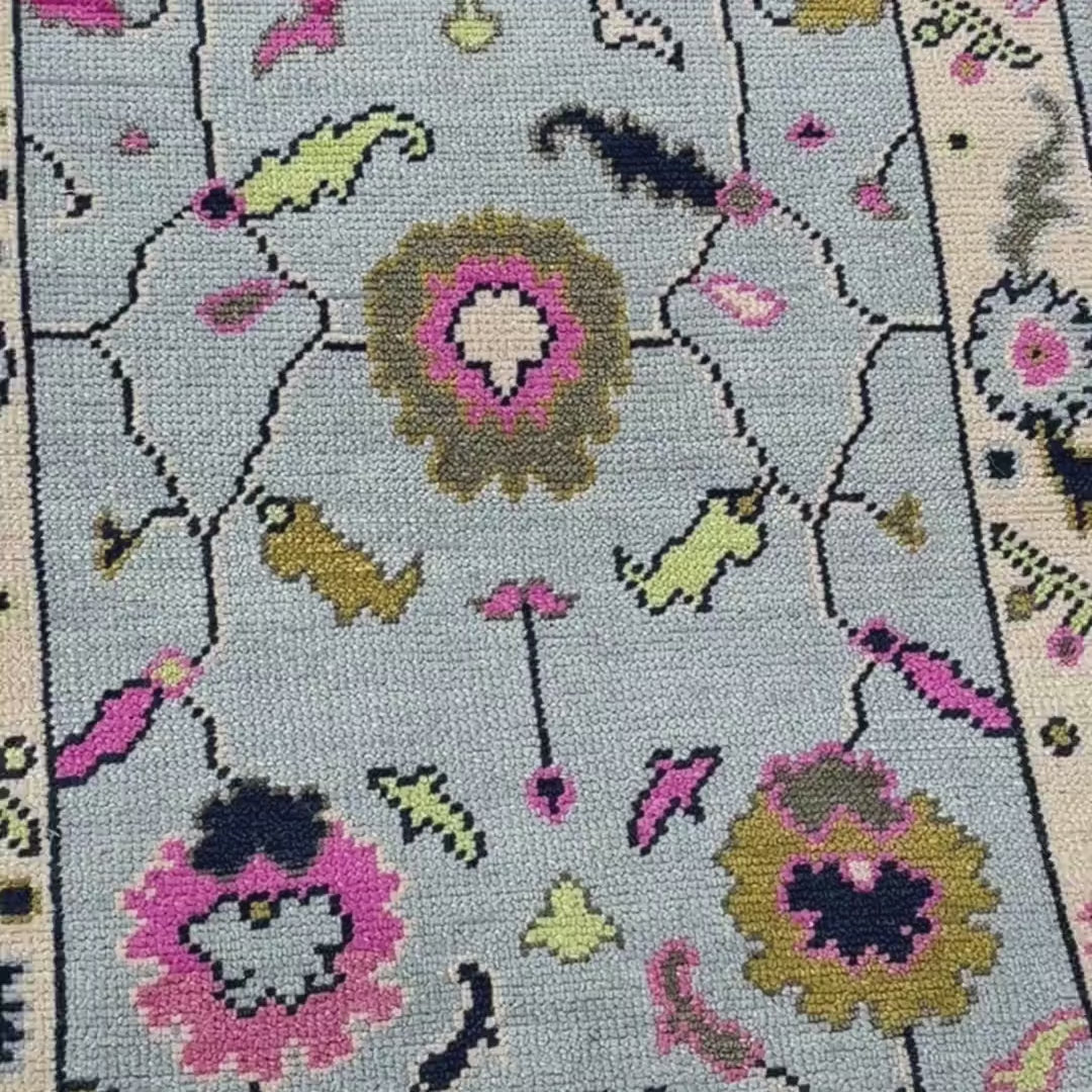 Close-up of a floral-patterned rug on a textured surface