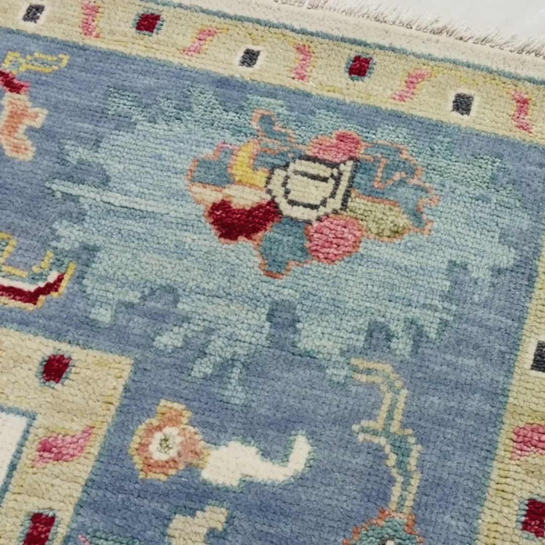 Close-up of a patterned rug with a visible brand label.
