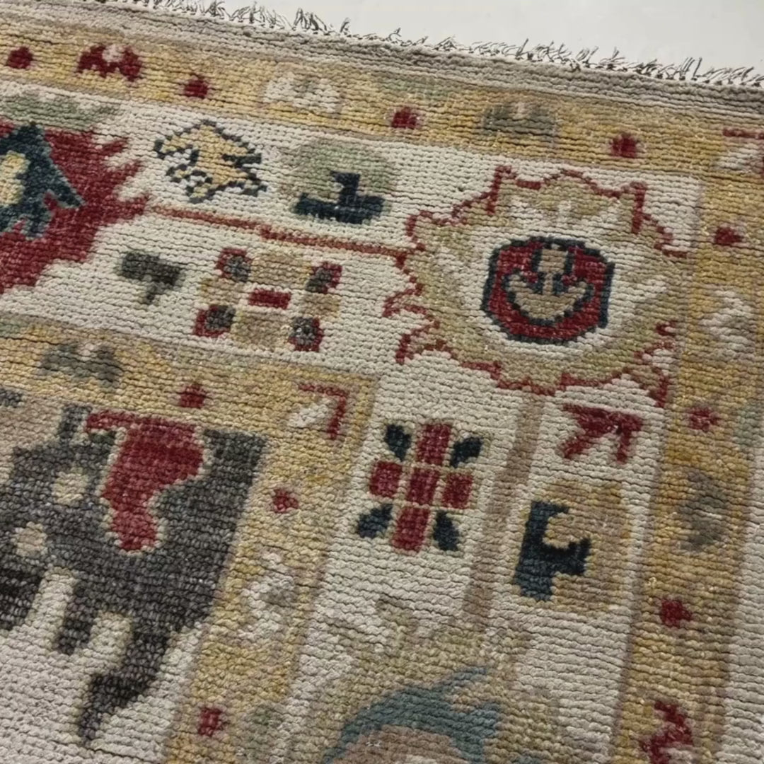 Close-up of a patterned rug with a visible textures.