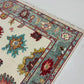 Close-up of a patterned rug with a visible textures.