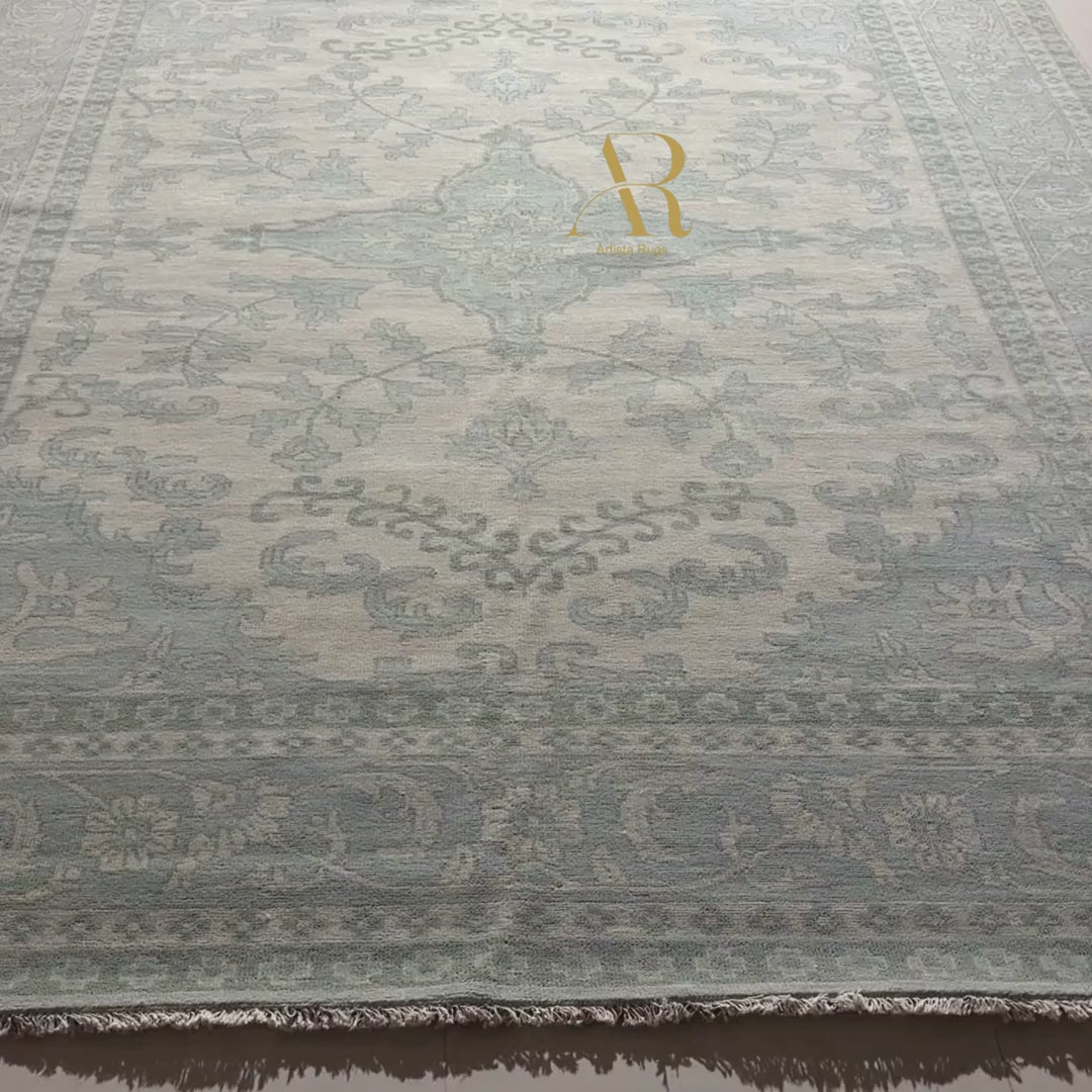 Roll of patterned fabric with a brand logo on a dark surface