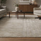 Beige patterned rug on a wooden floor with side table