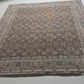 Decorative rug with intricate patterns on a plain background