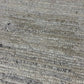 Close-up of a patterned rug with a visible textures.