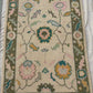 Floral patterned rug with colorful flowers on a neutral background