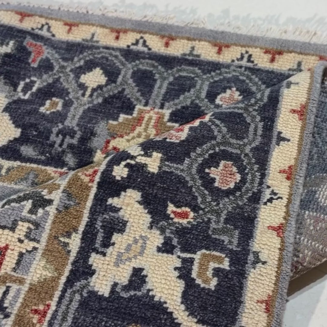 Close-up of a patterned rug with a visible textures.