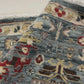 Close-up of a patterned rug with a visible textures.