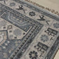 Close-up of a patterned rug with a visible textures.