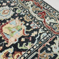 Close-up of a patterned rug with a visible textures.