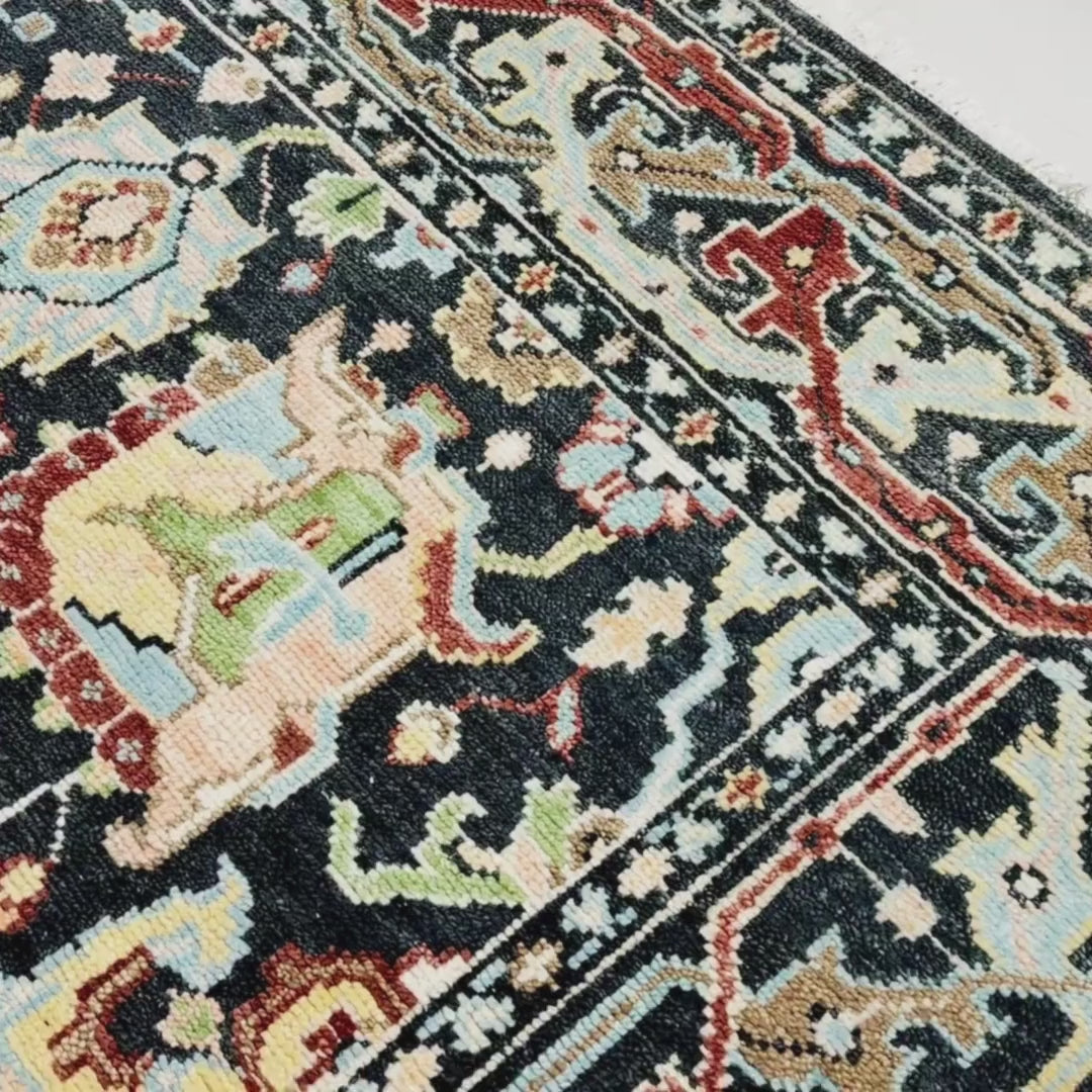 Close-up of a patterned rug with a visible textures.